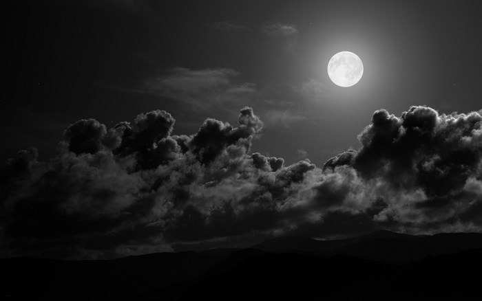 Full Moon Shining Over Dark Cloudy Night
