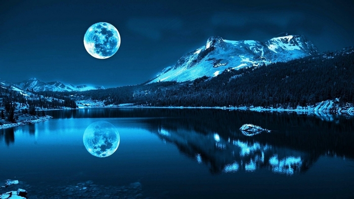 Blue moon over a mountain lake