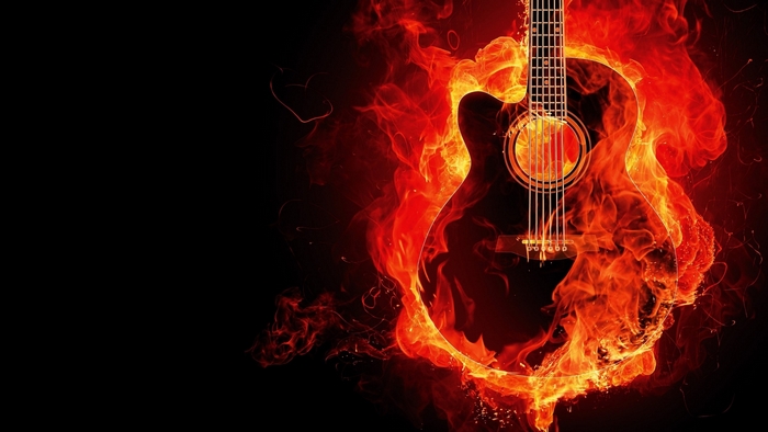 Acoustic guitar engulfed in flames