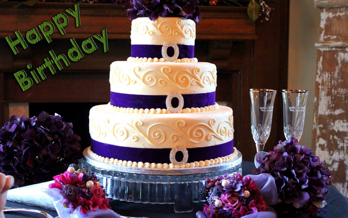 Happy Birthday Cake with Purple Flowers and Champagne Glasses
