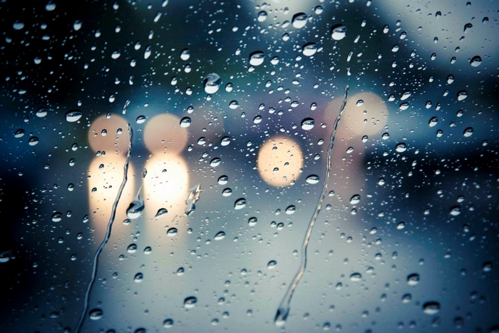 Raindrops on glass with bokeh lights