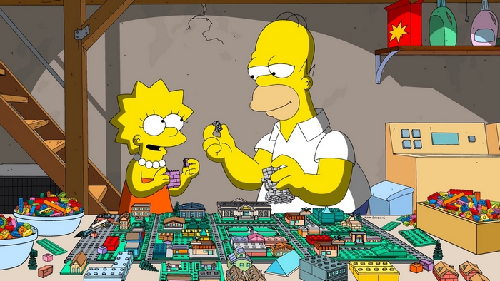 Homer and Lisa Simpson building with LEGOs