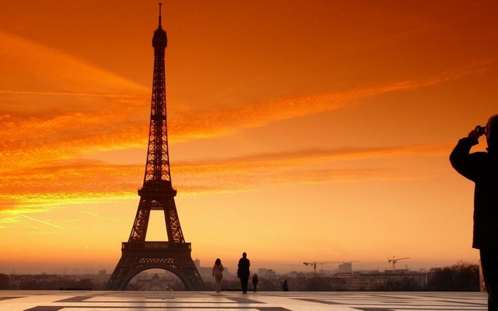 Eiffel Tower at sunset with people