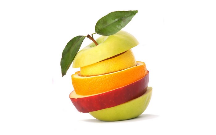 Sliced fruits stacked together with leaves