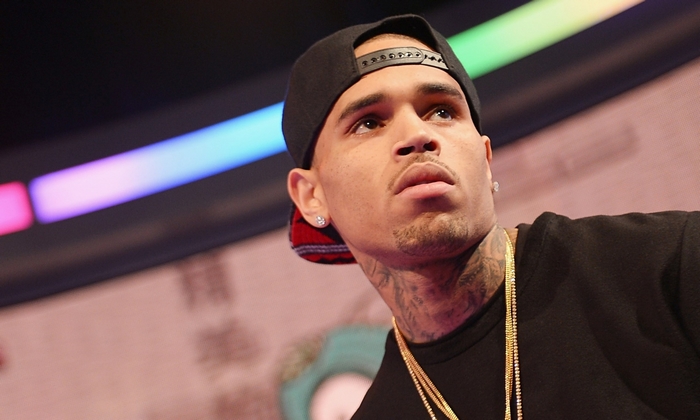 Chris Brown wearing a black baseball cap