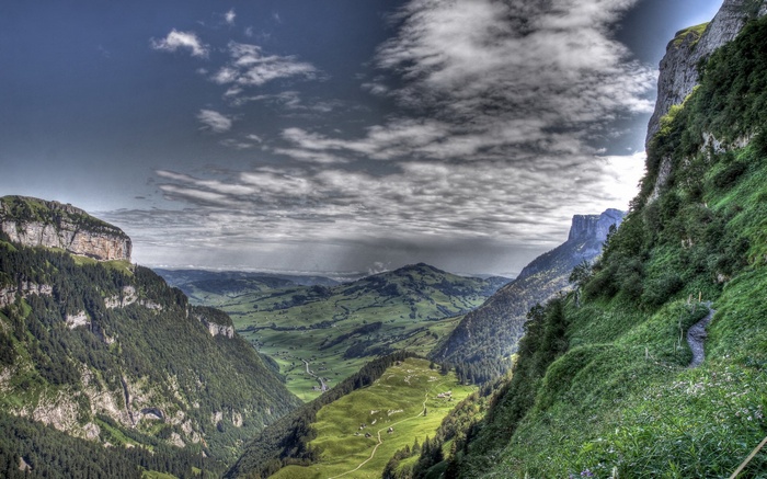Green mountain valley with dramatic clouds