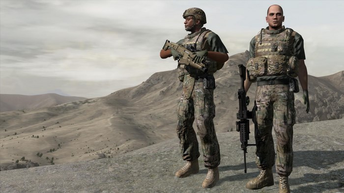Two US Army soldiers in a desert landscape