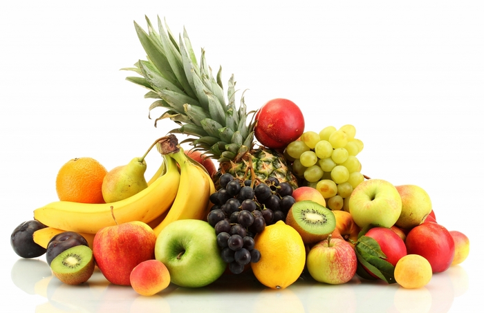 Assortment of fresh fruits including bananas, apples, grapes, and pineapple