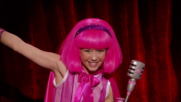 Stephanie from LazyTown singing into a microphone