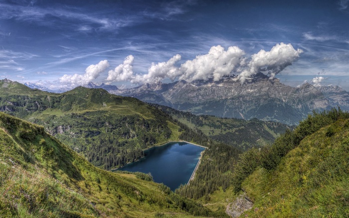 Mountain lake surrounded by trees and peaks