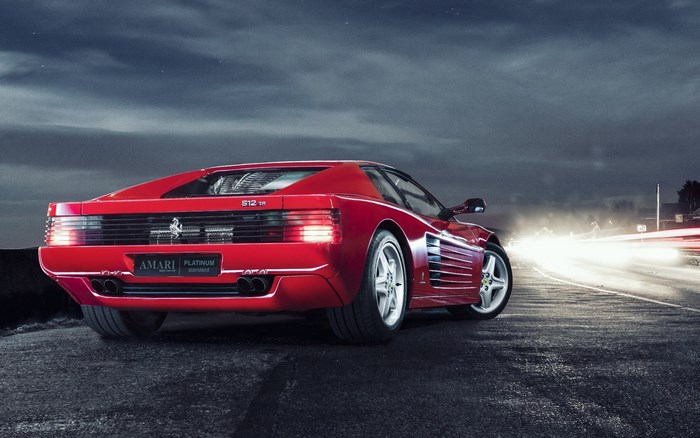 Red Ferrari 512 TR driving at night