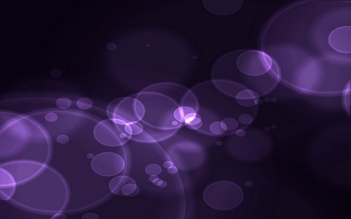 Purple bokeh circles on dark background