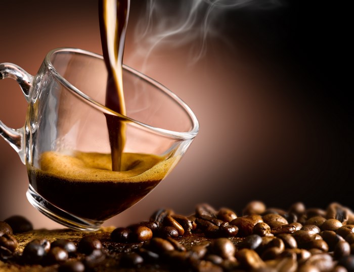 Steaming Coffee Pour with Coffee Beans