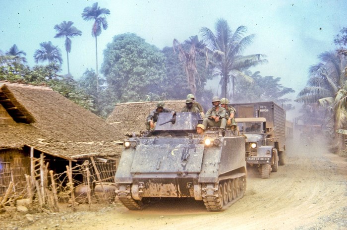 Vietnam War Military Convoy Through Jungle Village