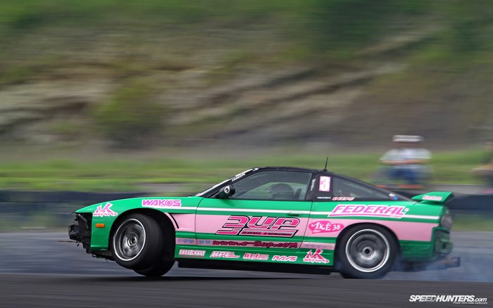 Green and pink drift car on track