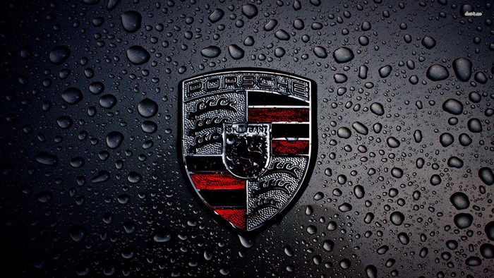 Porsche logo on a wet surface