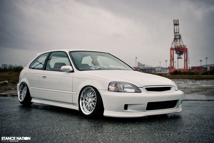 White Honda Civic hatchback with custom wheels