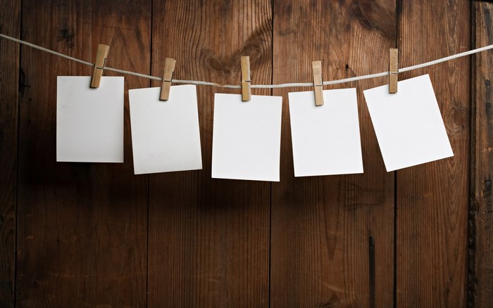 Empty white frames hanging on a clothesline