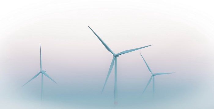 Wind turbines in a foggy landscape