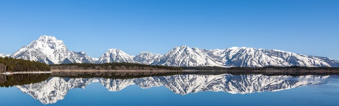 Snow-capped mountains reflected in a lake