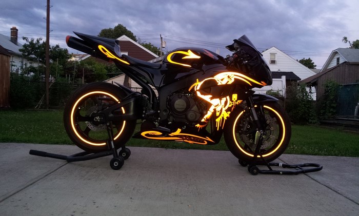 Black Honda CBR600RR motorcycle with reflective decals