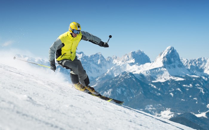 Man skiing down a snowy mountain slope