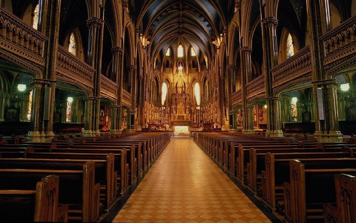 Interior of a grand church with pews and altar