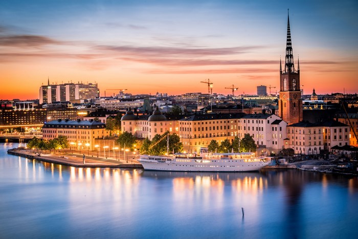 Stockholm cityscape at sunset with a boat