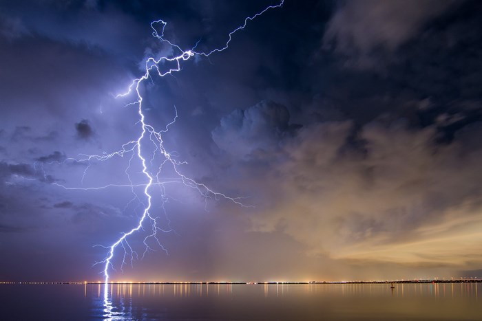 Lightning strike over water at night