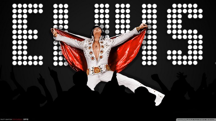 Elvis Presley performing on stage with lights