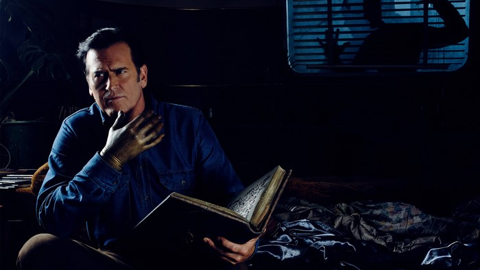 Ash Williams from Ash vs Evil Dead holding a book
