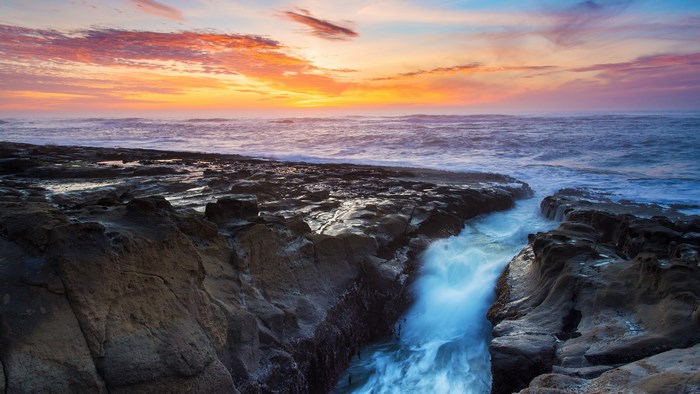 4K Widescreen Sunset Over Rocky Coastline