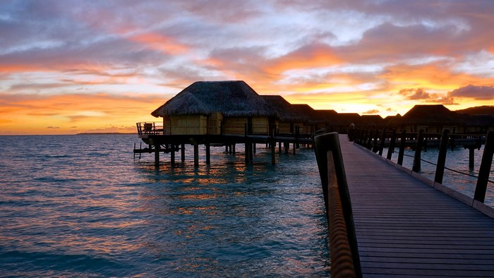 Overwater bungalows at sunset