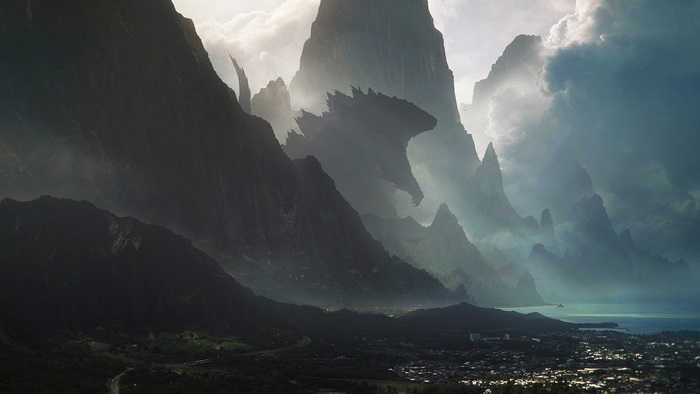 Godzilla emerging from mountains over a city