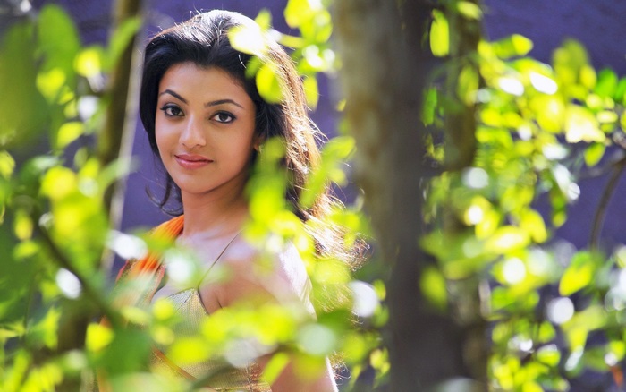 Kajal Agarwal portrait with foliage