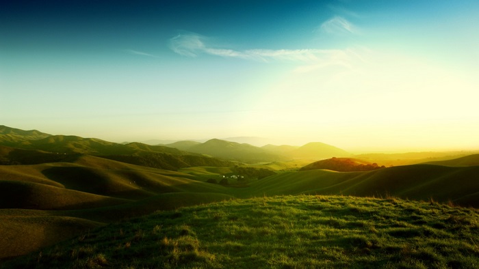 Rolling green hills at sunset