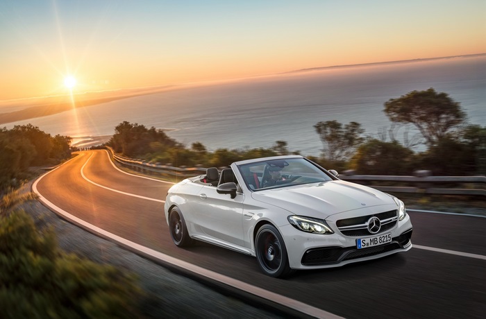 Mercedes-AMG C 63 S Cabriolet on a coastal road at sunset