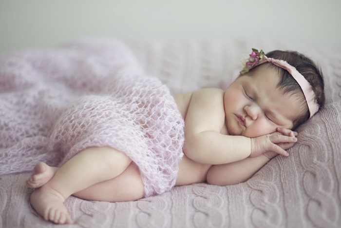 Cute baby sleeping on a pink blanket 4K