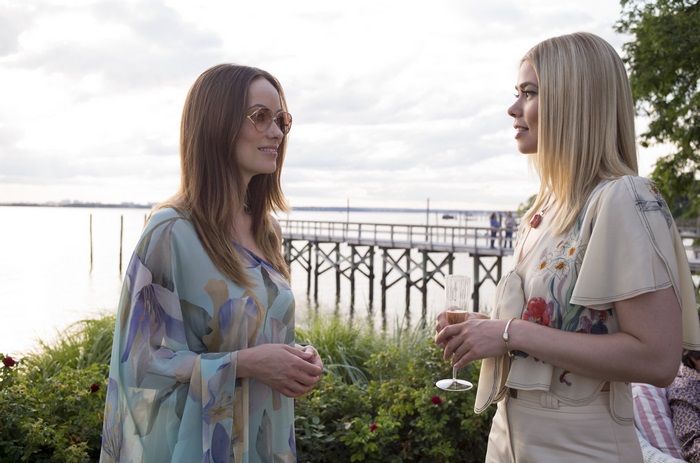 Two women talking by a pier