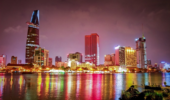 Ho Chi Minh City skyline at night with river reflection