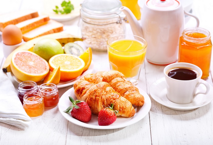Fresh Breakfast Spread with Croissants and Juice