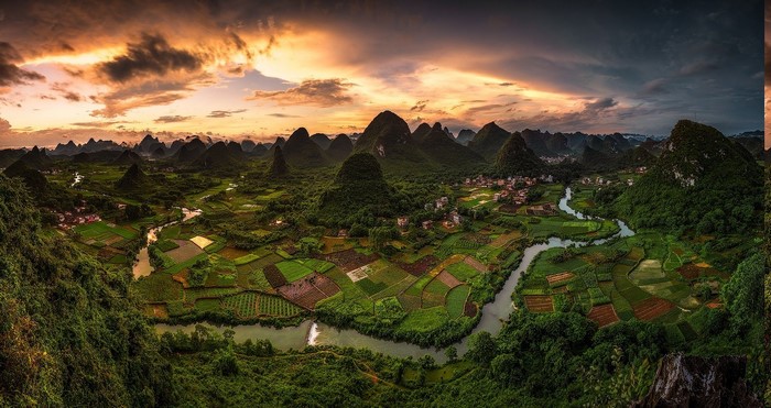 Karst landscape with river and rice fields at sunset
