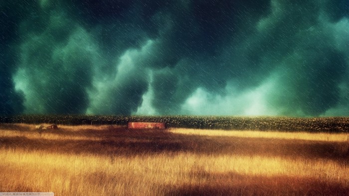Stormy sky over a field with a brick structure
