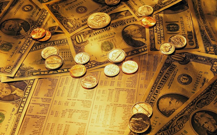 US Dollar Bills and Coins Scattered