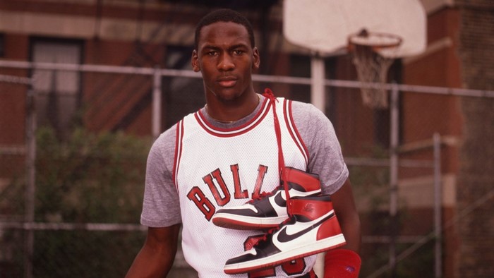 Michael Jordan holding Nike Air Jordan 1s