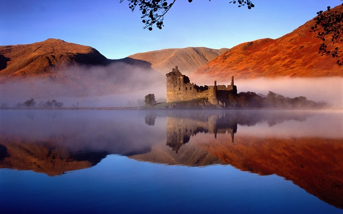 Castle Eilean Donan on a misty lake in Scotland