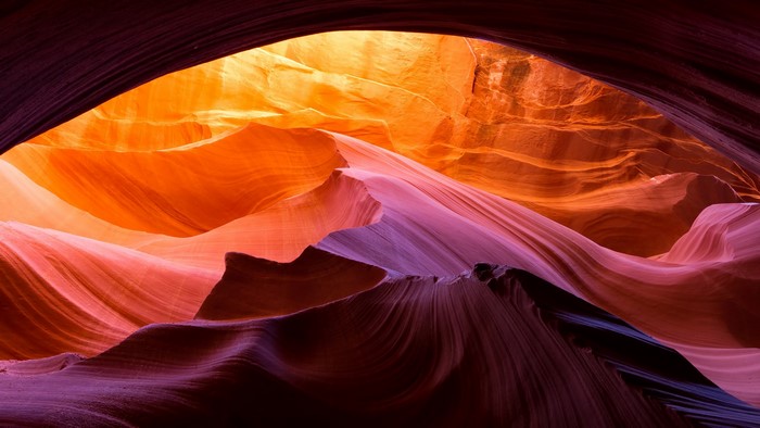 Colorful rock formations in a canyon with light