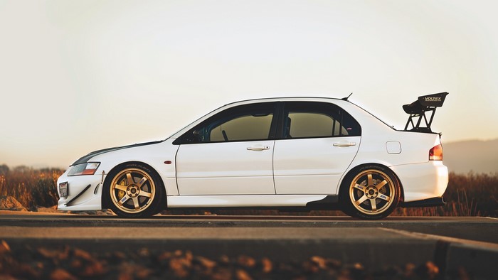 White Mitsubishi Lancer Evolution with Gold Wheels