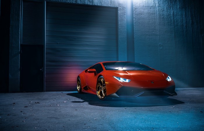 Red Lamborghini Huracan LP 610-4 parked outside garage