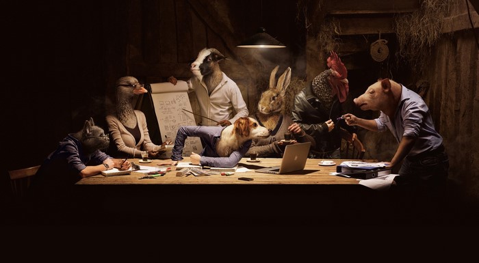 Animals in business attire having a meeting around a table